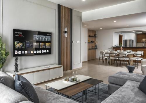 a living room with a couch and a table at Desert Key - Platinum Apartments in Gate Tower, Al Reem Island in Abu Dhabi