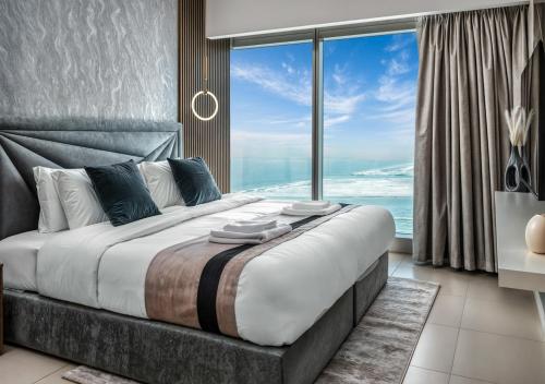 a bedroom with a large bed with a large window at Desert Key - Platinum Apartments in Gate Tower, Al Reem Island in Abu Dhabi