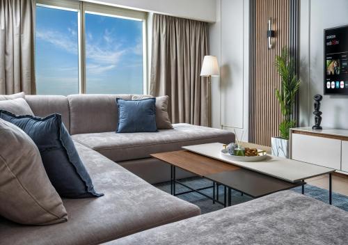 a living room with a couch and a table at Desert Key - Platinum Apartments in Gate Tower, Al Reem Island in Abu Dhabi