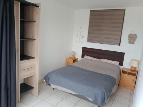 une chambre avec un lit et une étagère dans l'établissement Appartement, Résidence Grand Pavois, 28 rue Anatole France, lumineux, plein centre, tout à pied, parking privé, ascenseur, arrivée autonome,, au Havre