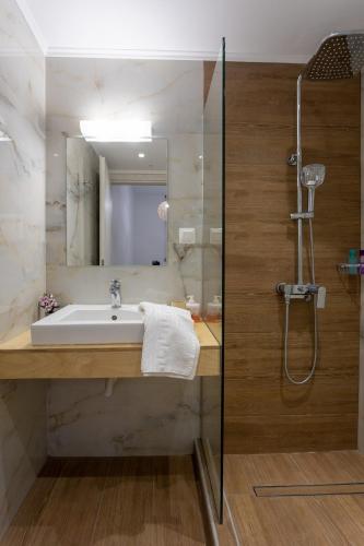 a bathroom with a sink and a shower at Avra 4 amazing house by the sea in Tsoútsouros