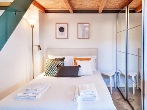a bedroom with a large white bed with pillows at House with exclusive terrace in a private condo in Porto