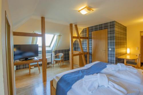a bedroom with a bed and a flat screen tv at Ferien Residenz Thüringer Wald in Masserberg