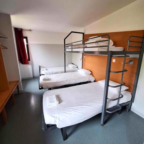 a room with three bunk beds in it at CIS de Champagne - Ethic Etapes in Reims