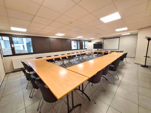 a large conference room with a long table and chairs at CIS de Champagne - Ethic Etapes in Reims