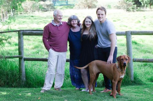 a family posing for a picture with a dog at Kairos Lodge in Hout Bay