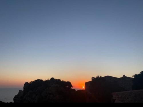 an image of a sunset in the mountains at Roccette OndaTURCHESE, Vista Mare e Jacuzzi Privata in Costa Paradiso