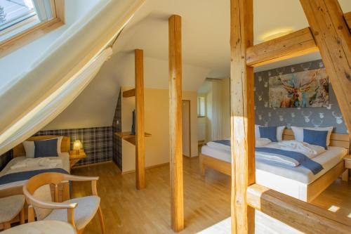 a bedroom with two bunk beds in a attic at Ferien Residenz Thüringer Wald in Masserberg