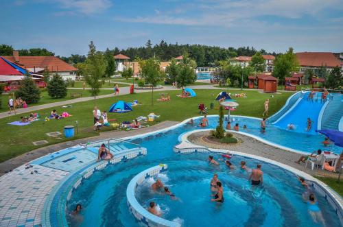 a group of people in a pool at a resort at Ceglédi Apartmanpark & Kemping in Cegléd