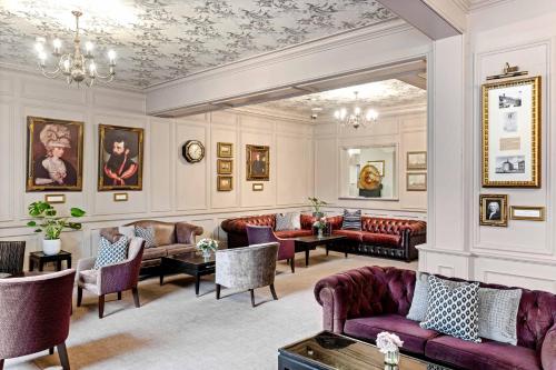 a living room with couches and tables at Dukes Head Hotel Kings Lynn in Kings Lynn