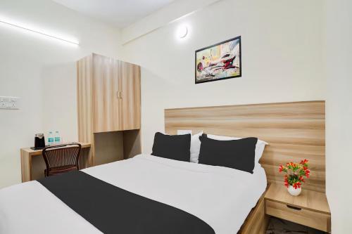 a hotel room with a bed and a desk at RG Suites HSR layout in Bengaluru