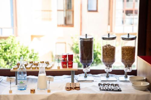 a table with three containers of food on a table at Moon Dreams Noja in Noja