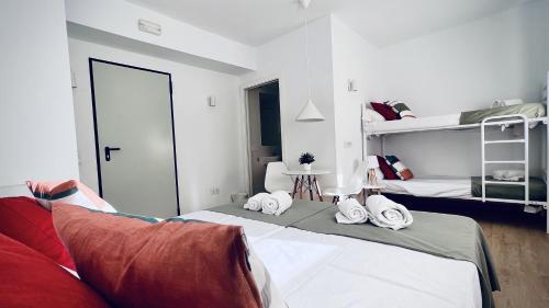 a bedroom with a bed and bunk beds in it at Hostal by El Collell TODO INCLUIDO in Sant Ferriol