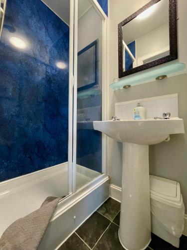 a bathroom with a sink and a shower at Vaila Guest House in Aberdeen