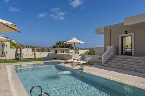 a swimming pool in front of a house at Elysian Villa 2 With Private Pool in Roumelí