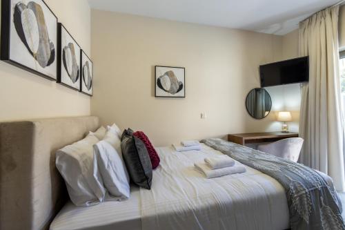 a bedroom with a bed with pillows on it at Elysian Villa 2 With Private Pool in Roumelí