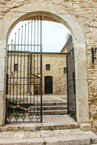 an entrance to a stone building with an iron gate at Castel di Pietra in Pietra Montecorvino