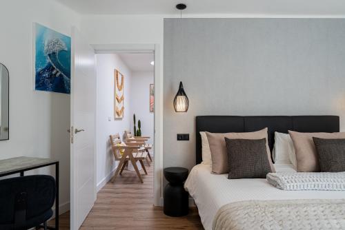 a bedroom with a bed and a dining room at Villa Las Marias Suite - Playa Roca Residence in Costa Teguise