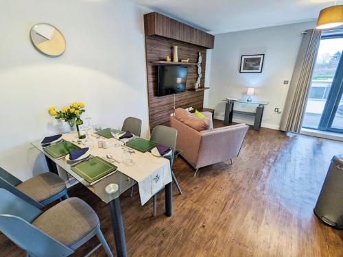 a dining room with a table and chairs and a couch at Folly View in Newport