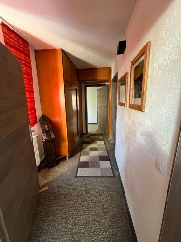 a hallway with a checkered floor in a building at Dorfgalerie Lahntal in Villmar
