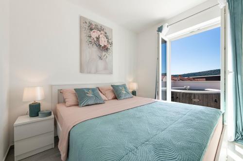 a bedroom with a bed and a large window at Apartments Kiki in Mlini