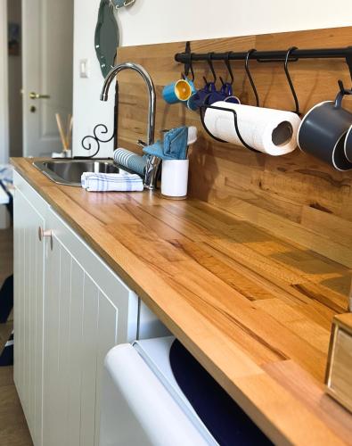 a kitchen with a sink and a wooden counter top at Palazzo Donnamaria in Manfredonia