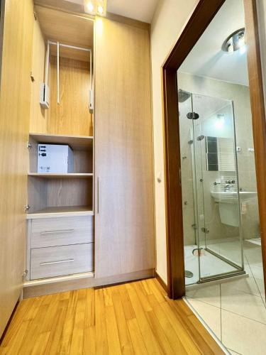 a bathroom with a shower and a glass door at Dunai panoráma in Budapest