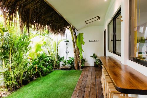 an indoor garden with a bench and grass at Casa Malia Siargao in General Luna