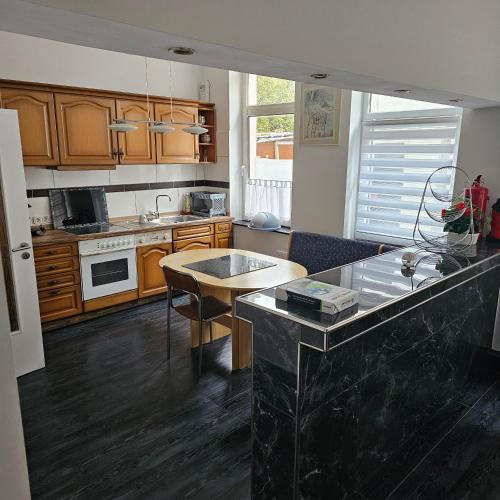 a kitchen with wooden cabinets and a counter top at HafenApartement in Bremerhaven