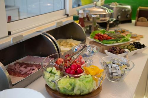 a buffet filled with different types of food on a counter at Casa Boca in Cluj-Napoca