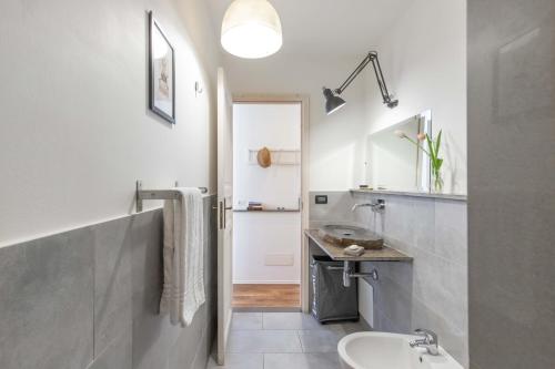 a white bathroom with a sink and a toilet at 900 - Guest House in Livorno