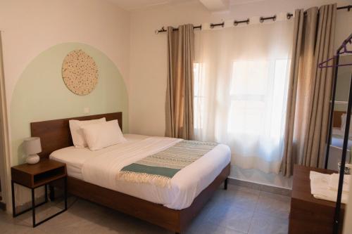 a bedroom with a bed and a window at Kalih Villa in Kigali