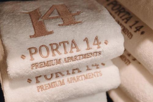 a pile of white towels with the number on them at Apartamento Porta14 1 in Chaves