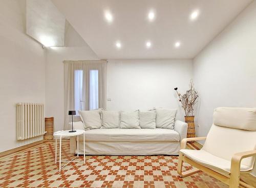 a living room with a couch and a table and chairs at La Dolce Lidia / Casa in Salento vicino al mare in Spongano