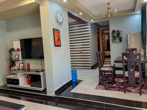 a living room with a television and a table and chairs at Benja holiday home in Katale