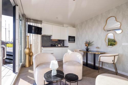 a kitchen and living room with a table and chairs at Holland Houseboat Lemmer in Lemmer