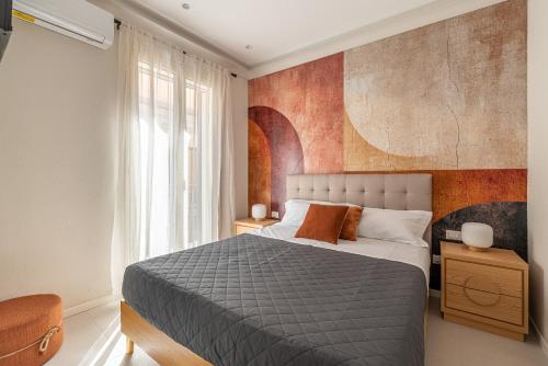 a bedroom with a bed and a large window at Le perle del capo in Palermo