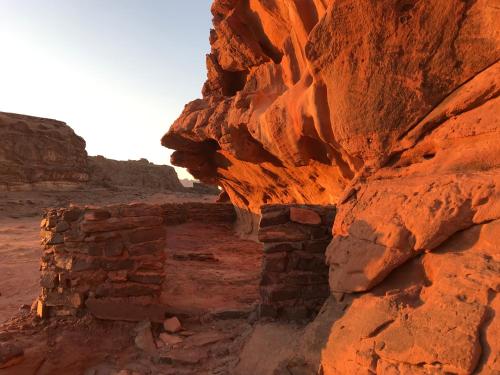 an old stone building in the desert at Wadi Rum Paris Cave in Wadi Rum