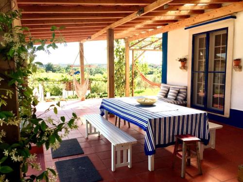 a patio with a table and a bench on it at Cottage with Pool,Gourmet BBQ,Wood Oven&Games Barn in Pontével