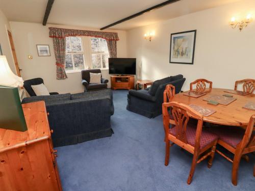a living room with a table and a dining room at Heatherview in Wooler