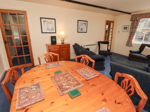 a dining room with a wooden table and chairs at Heatherview in Wooler
