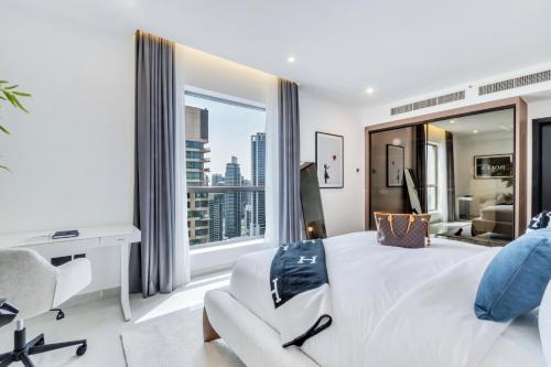 a bedroom with a large bed and a large window at Luxurious Brand New 2BR Apartment in Rimal 1 I Steps to the JBR Beach I GYL Holiday Homes in Dubai