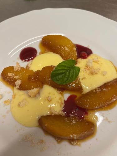 a plate of food with fruit and a green leaf at Hotel la Maggioressa in Ischia