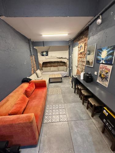 a living room with a large brown couch in a room at Archeo in Istanbul