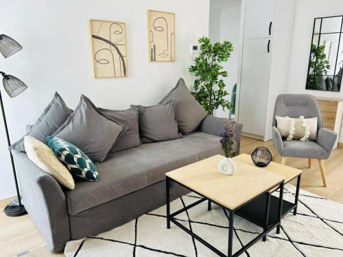 a living room with a gray couch and a table at Life Apartments Arcos 27 in Jerez de la Frontera