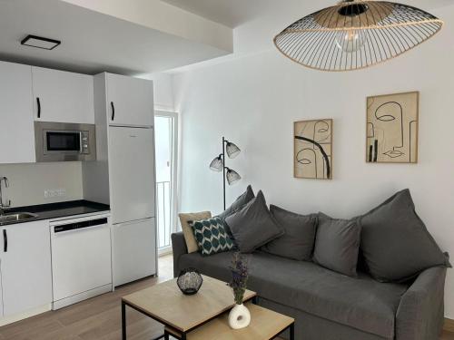 a living room with a couch and a table at Life Apartments Arcos 27 in Jerez de la Frontera