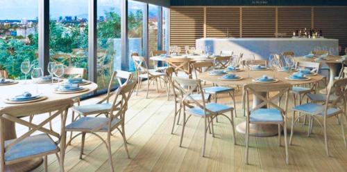 a dining room with tables and chairs and windows at Polanco Loft México City in Mexico City