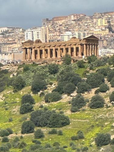 an ancient building on top of a hill with trees at Arc Home apartment in Agrigento
