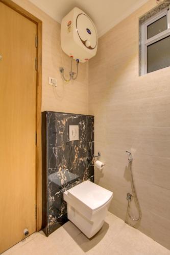 a bathroom with a toilet and a shower at Hotel Elevate Suites Near Delhi Airport WITH- Free Airport PICKUP in New Delhi