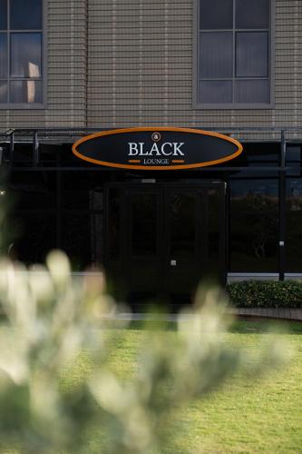 a black and orange sign on a building at Avec Hotel in Canakkale
